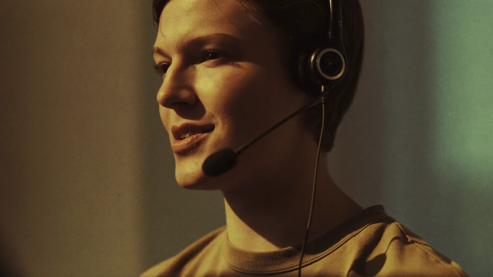 A sales rep wearing a headset practicing out loud in warm morning light.